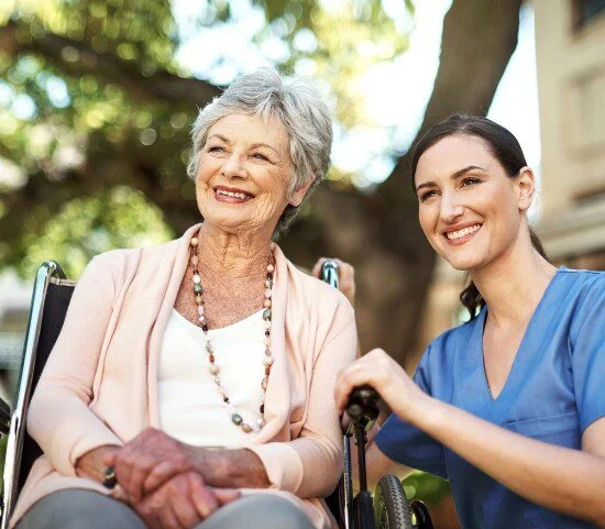 woman in wheelchair with nurse