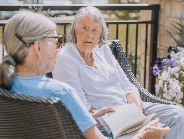 Two senior women having a conversation.