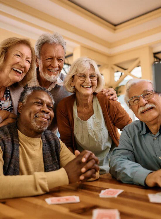 A group of senior friends takes a selfie.