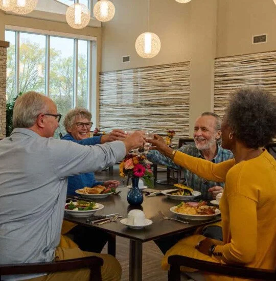 Four adults at table having drinks