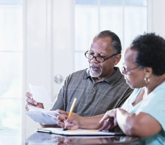 Senior couple at home paying bills