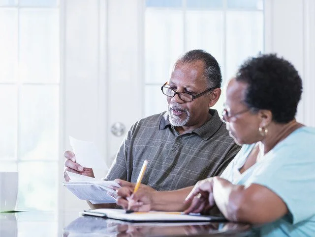 Senior couple at home paying bills