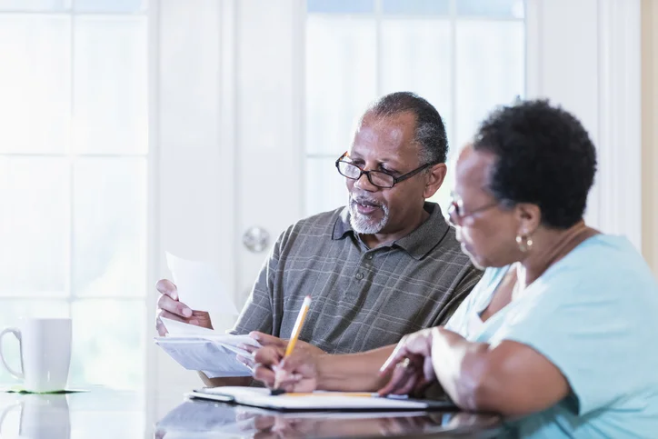 Senior couple at home paying bills