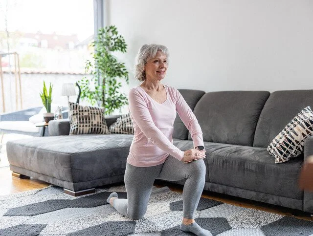 Senior Caucasian Woman Doing Lunge Stretch Exercise At Home