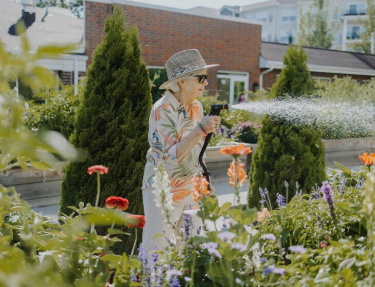 Resident volunteers watering flowers at Friendship Village of Bloomington, Minnesota
