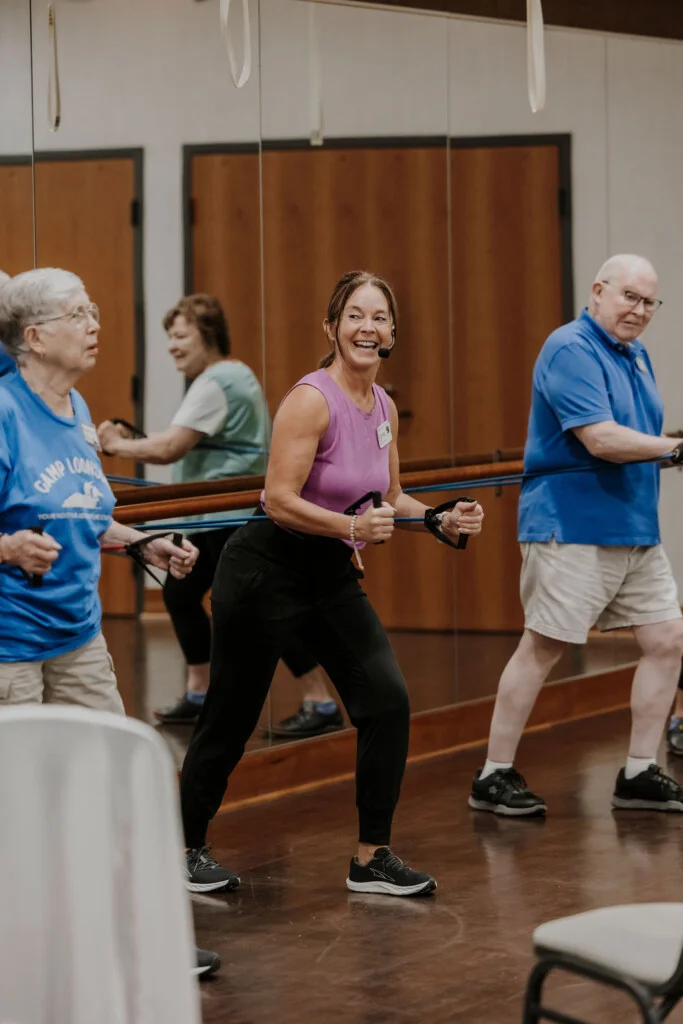Instructor leading a resistance band fitness class at Friendship Village of Bloomington