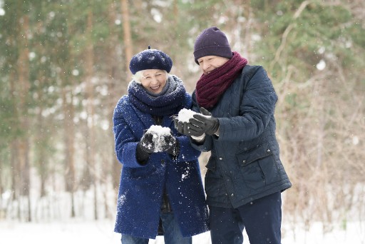 senior couple bundled up on a snowy day