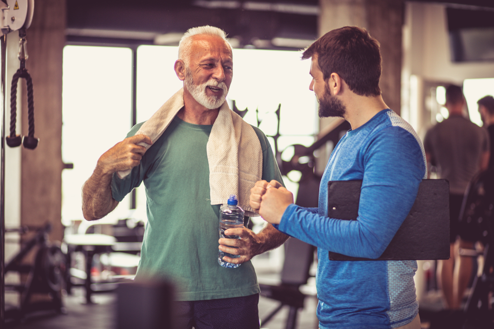 Senior man talking with someone after a workout