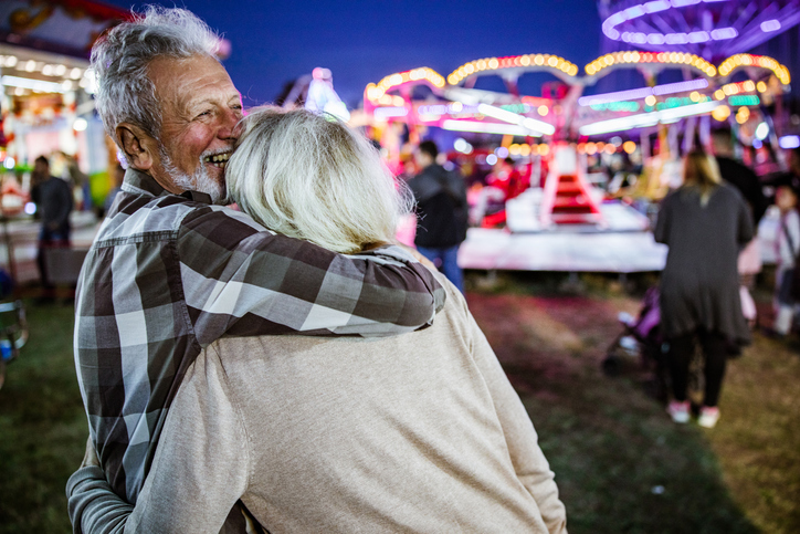 man hugging woman at a fair