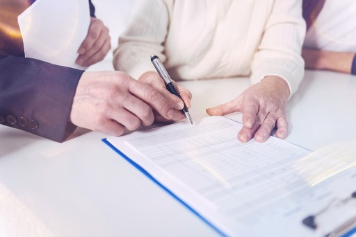 seniors signing a life care contract