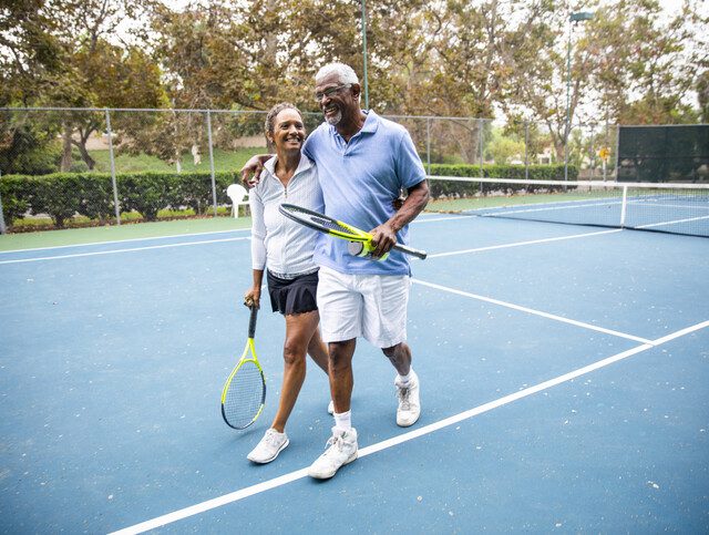 Senior Black Couple Walking Off the Tennis Court