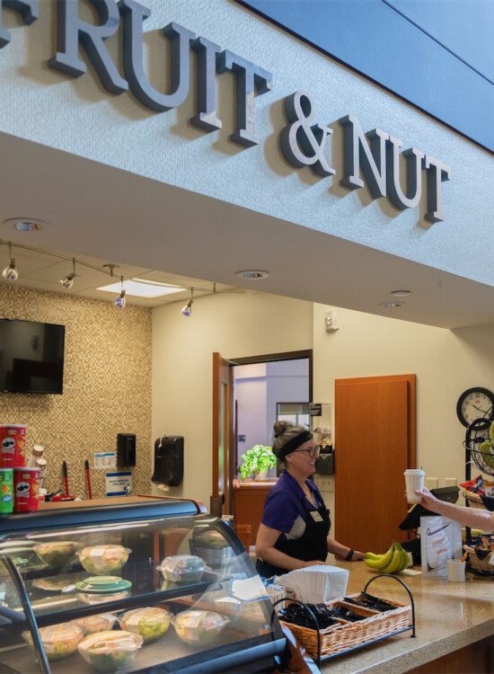 woman purchasing coffee from cafe counter