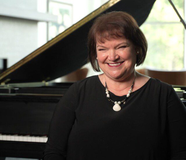 Woman in front of piano