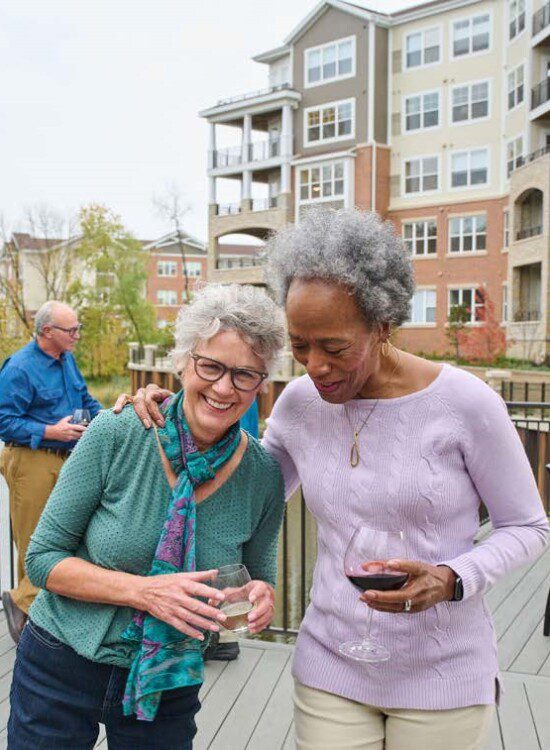 2 women outside with wine laughing