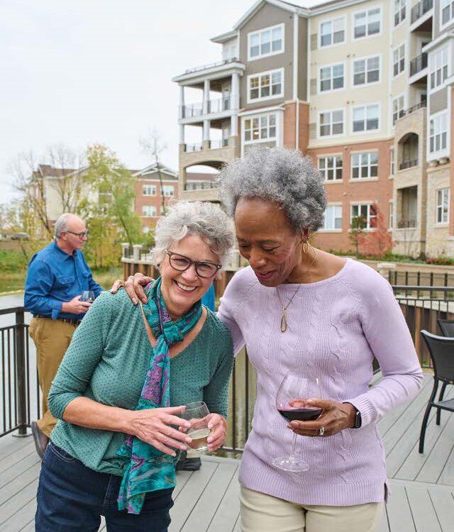 2 women outside with wine laughing