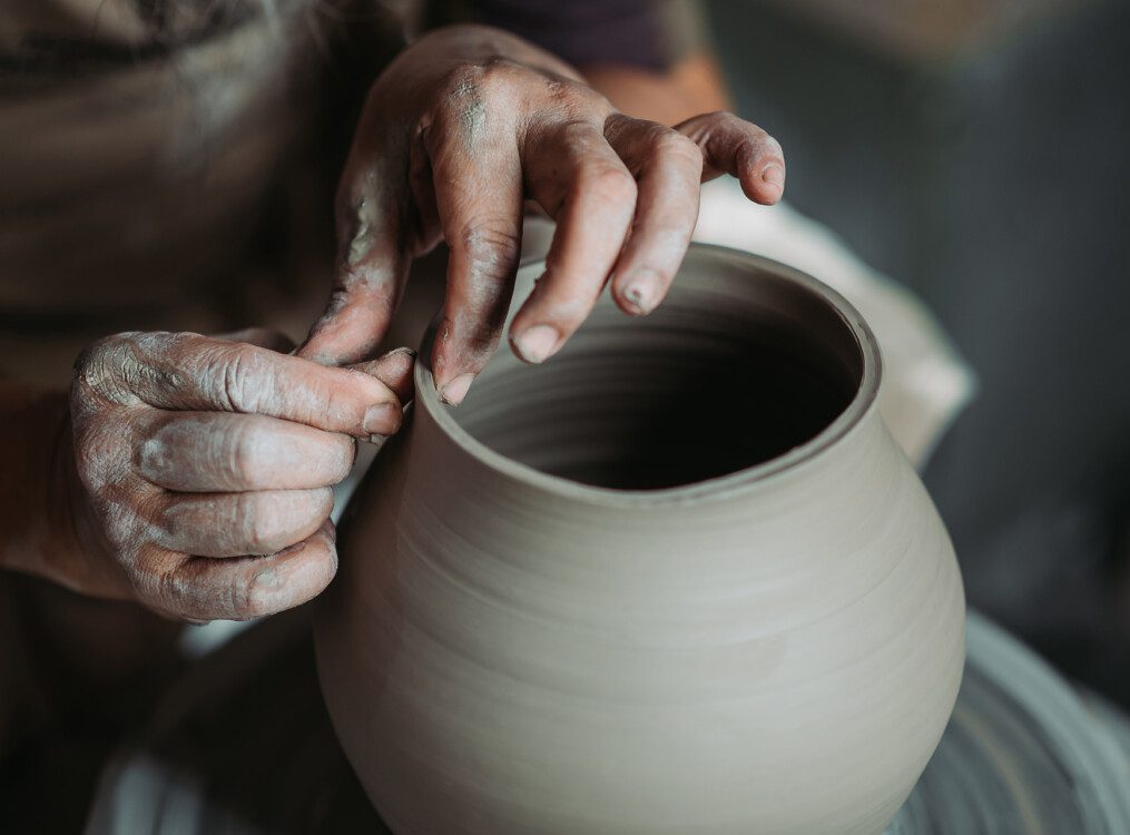 hands making pottery