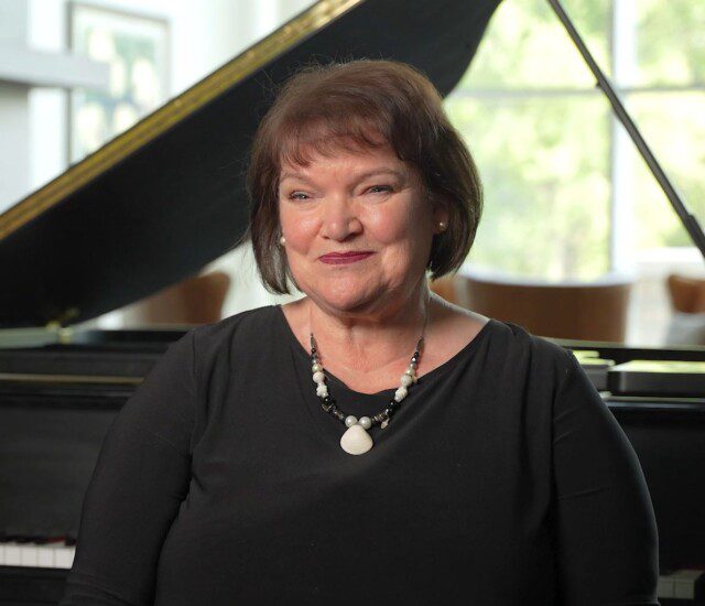 woman sitting at piano